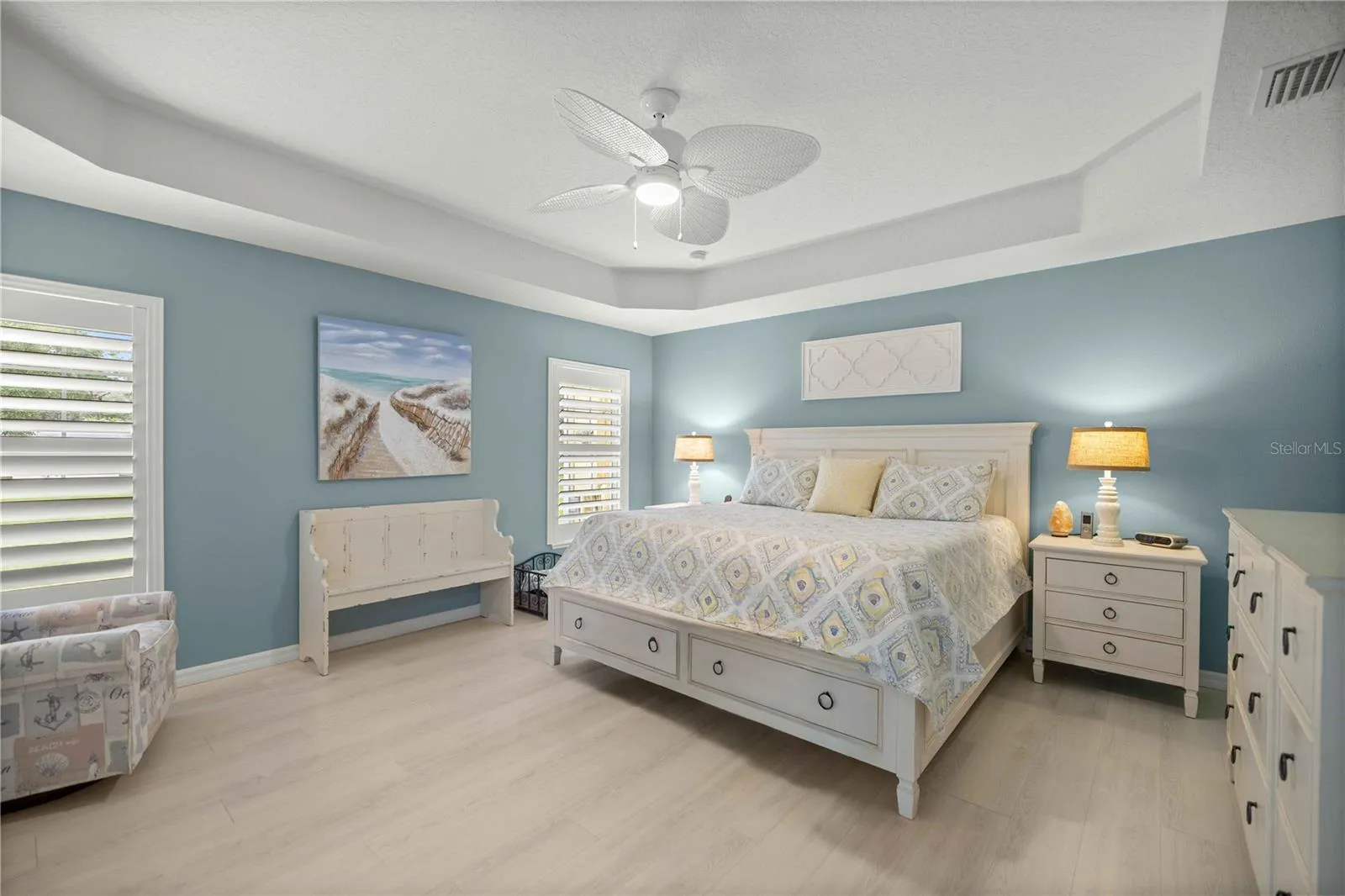 Primary bedroom with tray ceilings