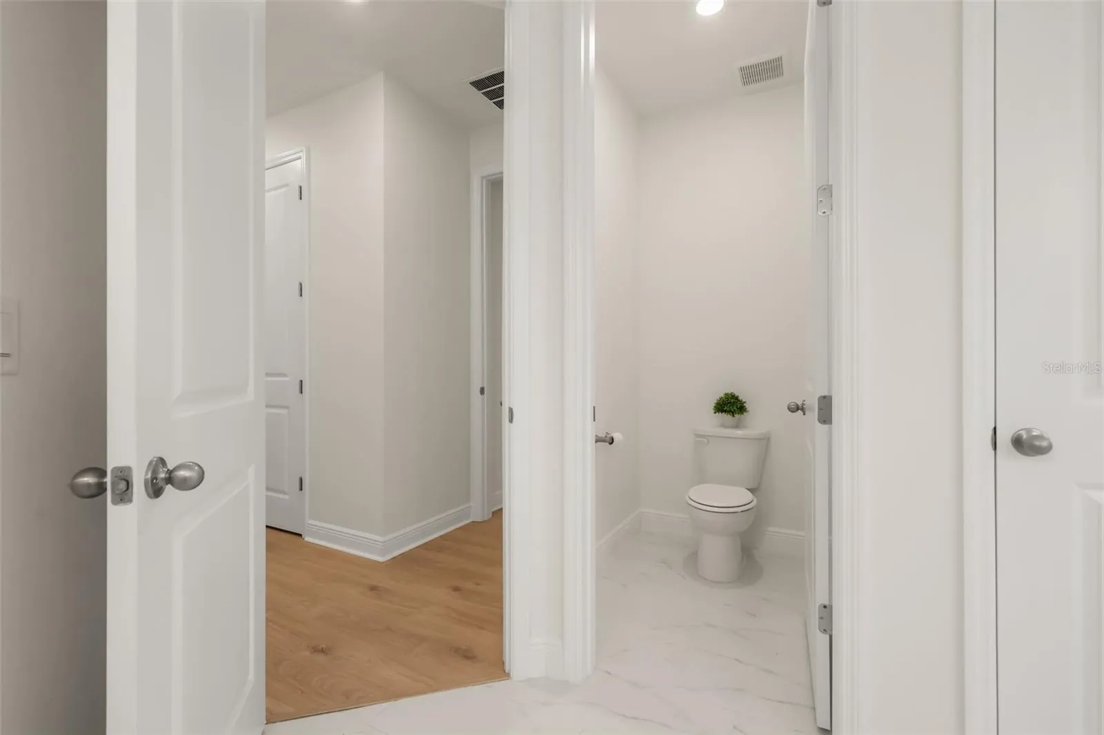 Luxurious primary bathroom with shower, dual vanity, soaker tub, and water closet