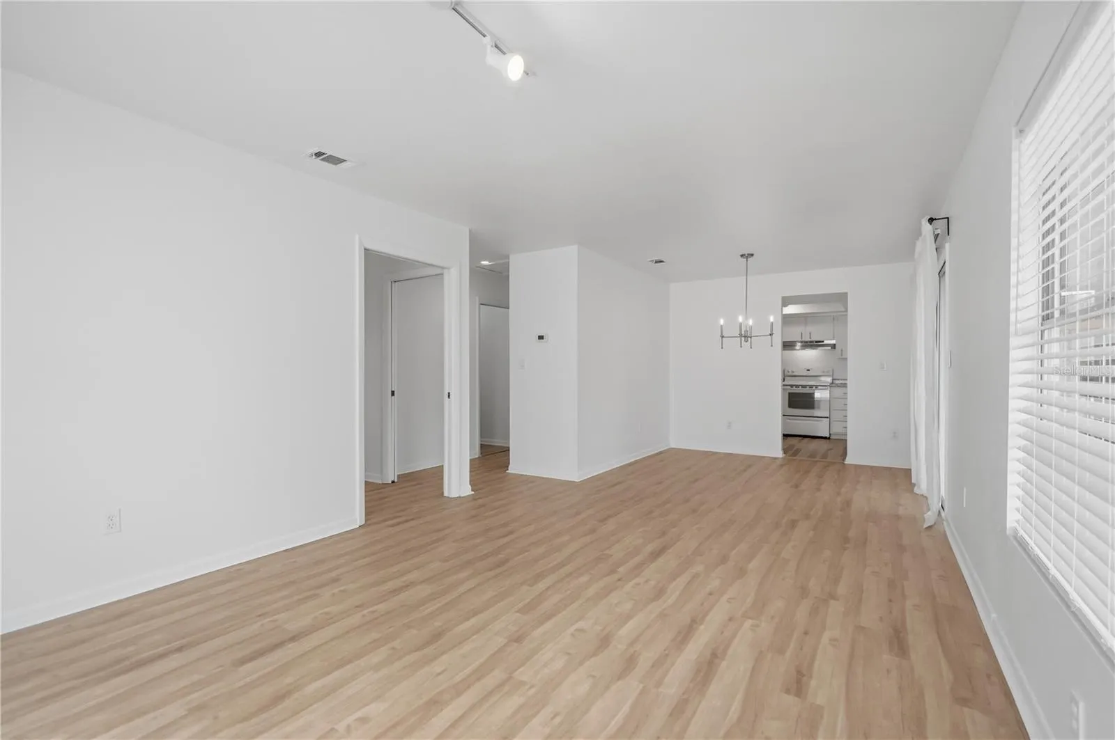 LIVING AREA LOOKING AT HALLWAY TO BEDROOMS AND KITCHEN