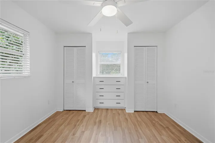 PRIMARY BEDROOM WITH BUILT IN DRESSER AND CLOSETS