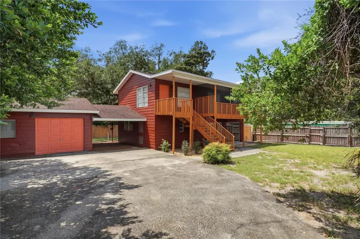 FRONT VIEW WITH CARPORT AND GARAGE