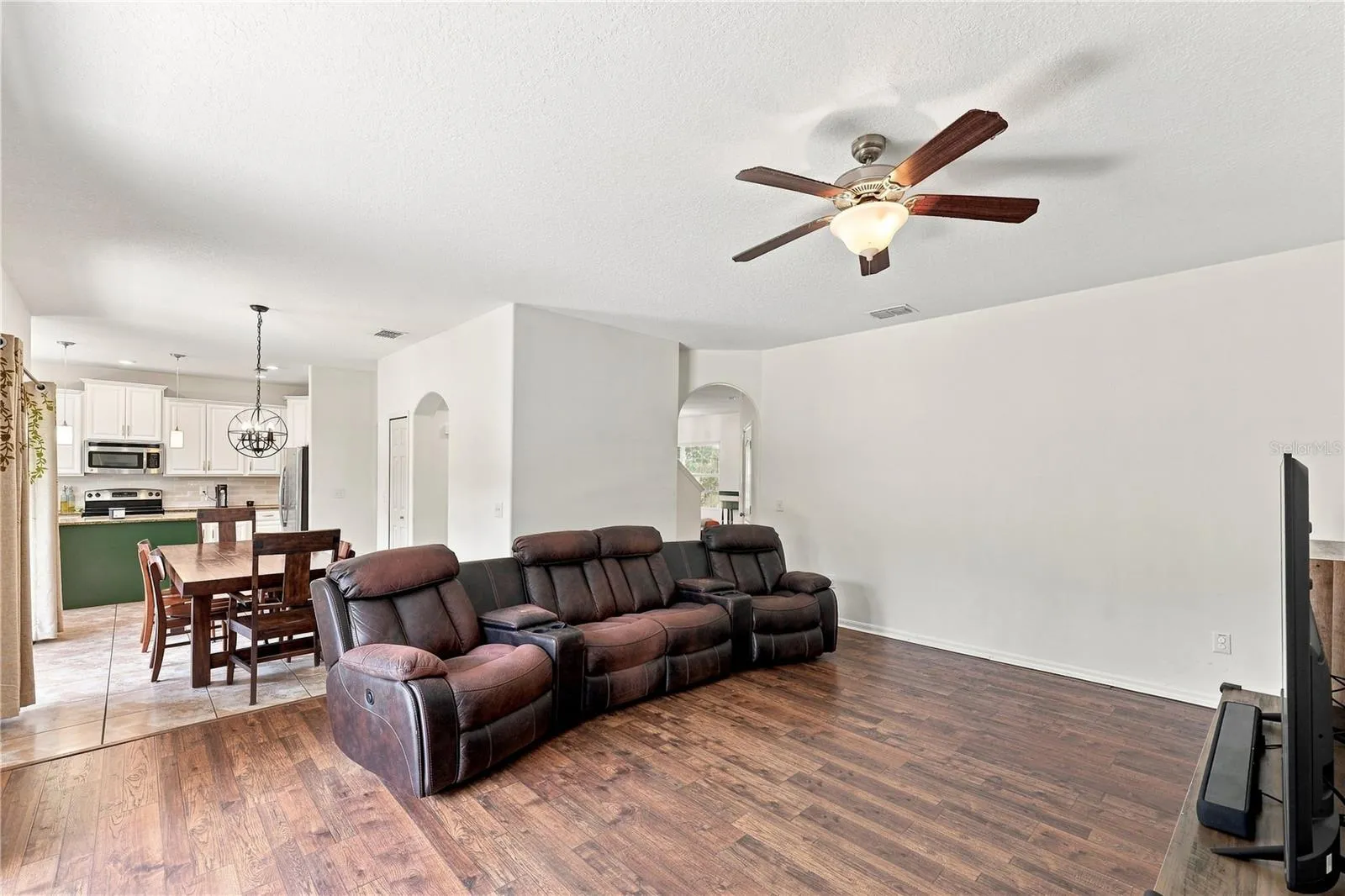 Living room large enough to hold multiple sofa pieces