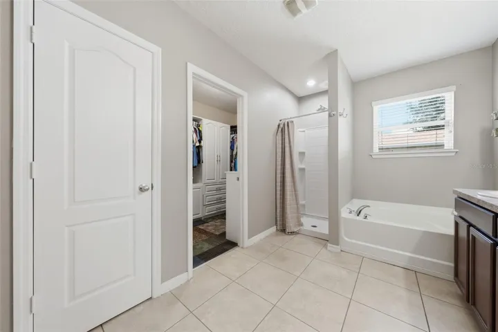 Primary Ensuite with soaking tub, shower, water closet, and walk-in closet