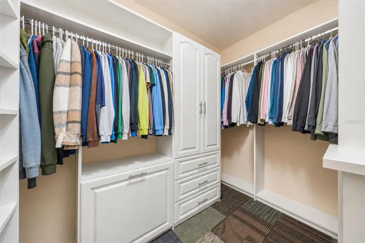 Large walk in primary closet with custom closet system