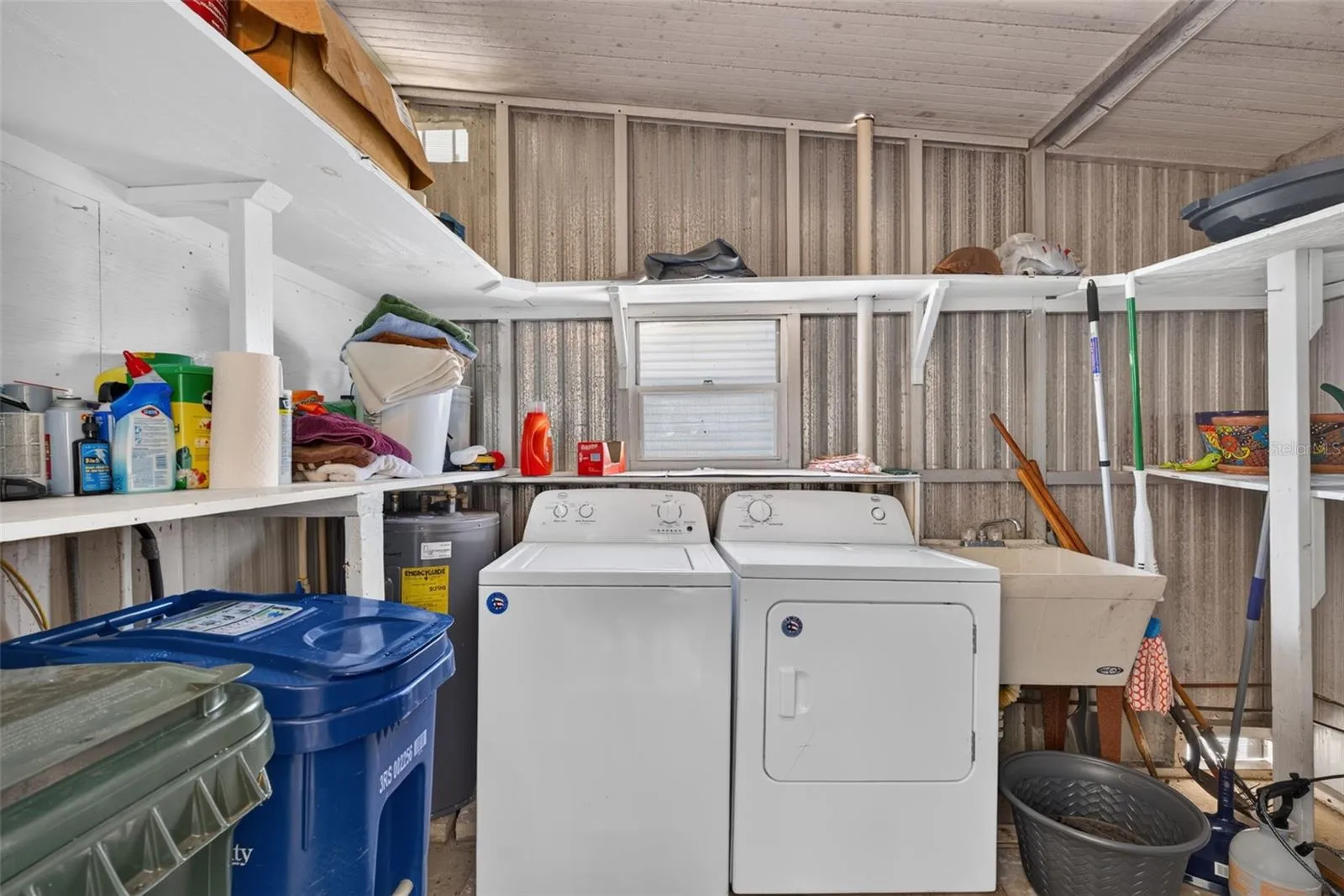 Washer dryer in shed with plenty of storage space