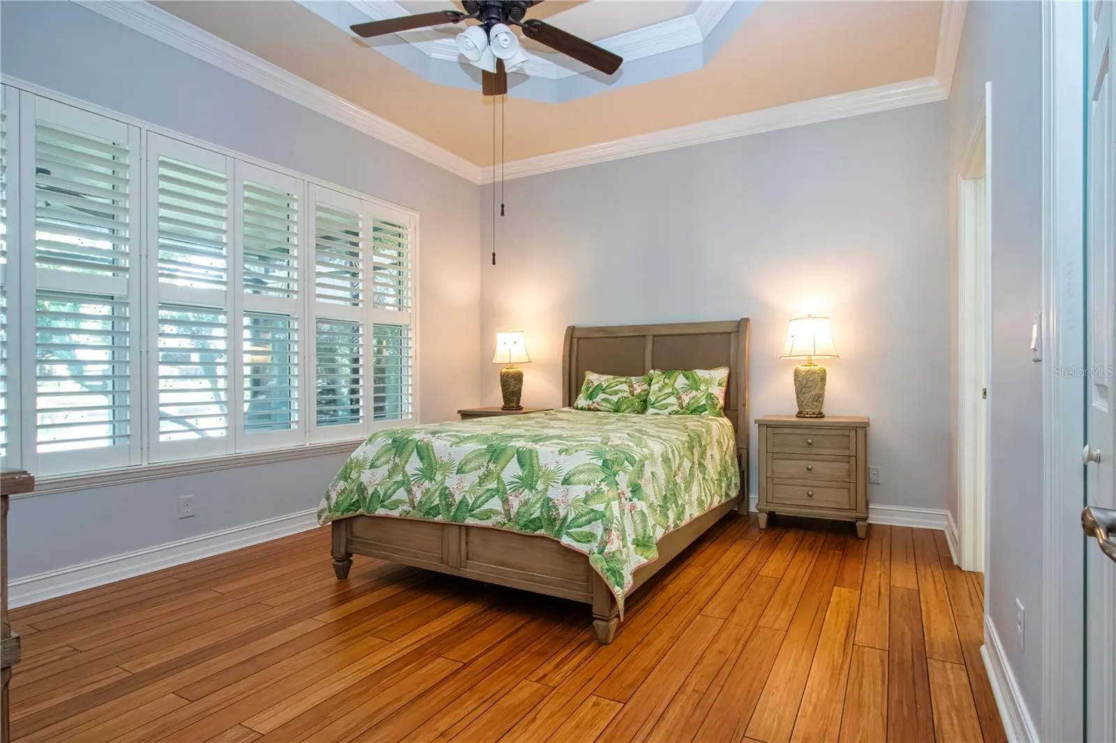 Primary Bedroom-coffered ceiling, plantation shutters,wood flooring