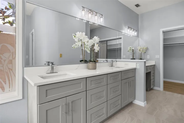 Double vanities with quartz counters.