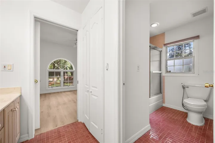 Views of tub/shower and toilet area in Jack-n-Jill bath