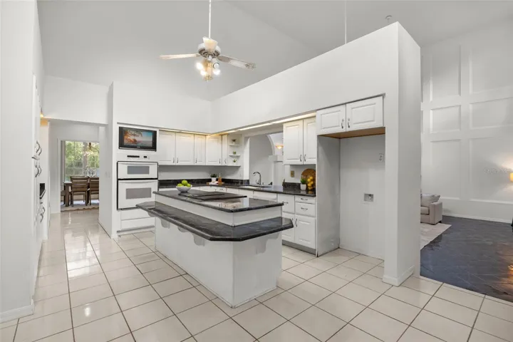 Kitchen with double ovens, island, wet bar and butler's pantry, views to Family room and lanai and an eat-in space