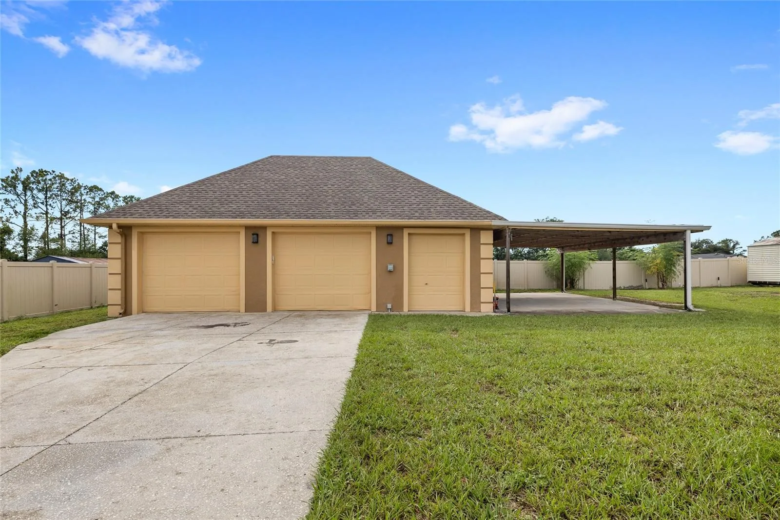 Detached two car garage with storage room, carport, and RV PLUG