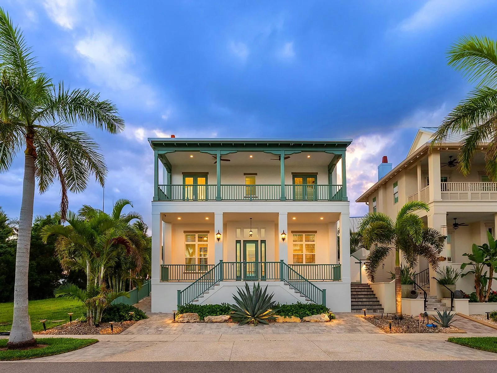 Elevated home has unobstructed water views, two river-facing outdoor covered spaces, and a 3-car garage with in-law suite in the rear
