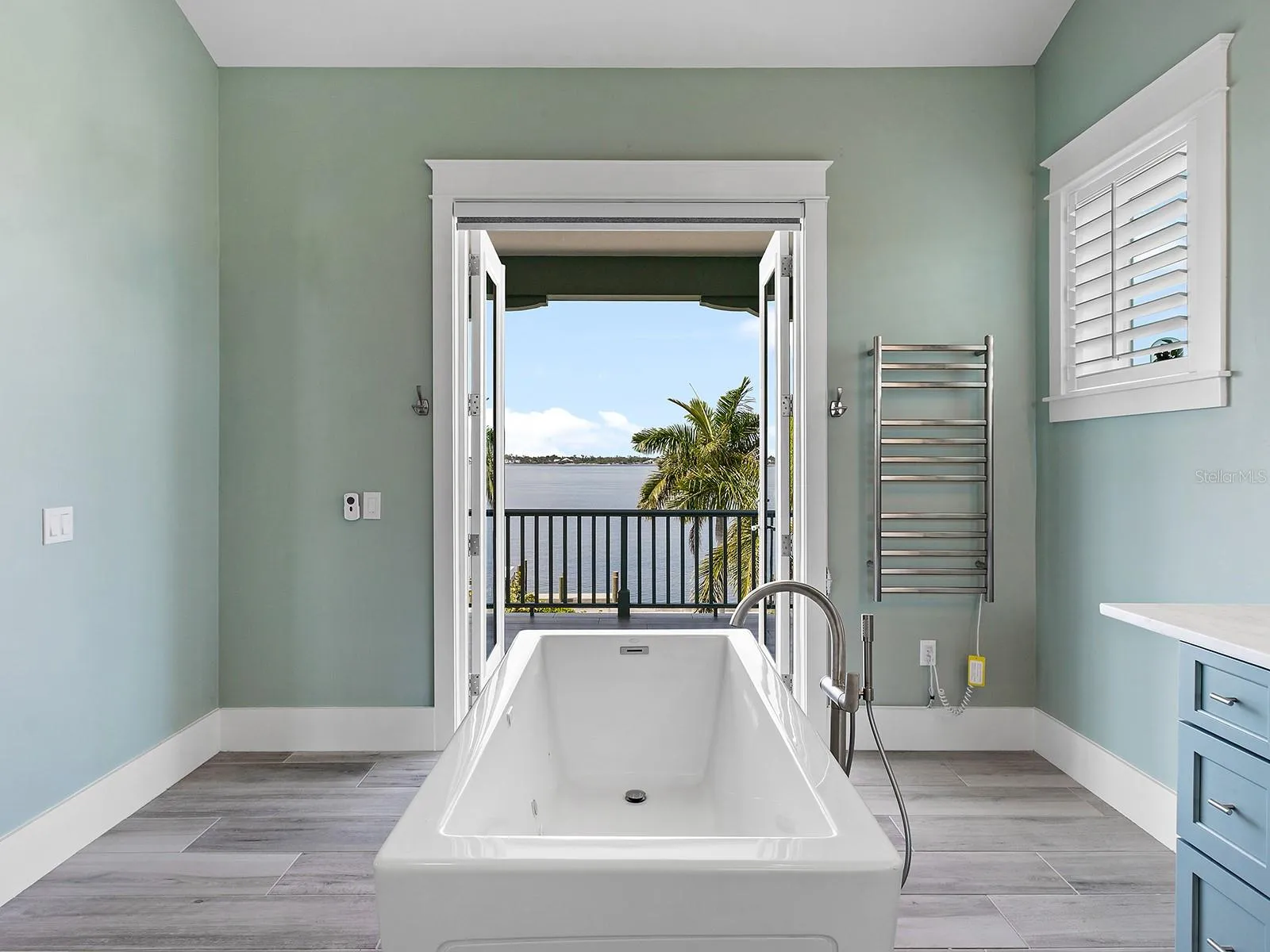 Freestanding soaking tub in the second floor primary bedroom with Manatee River views