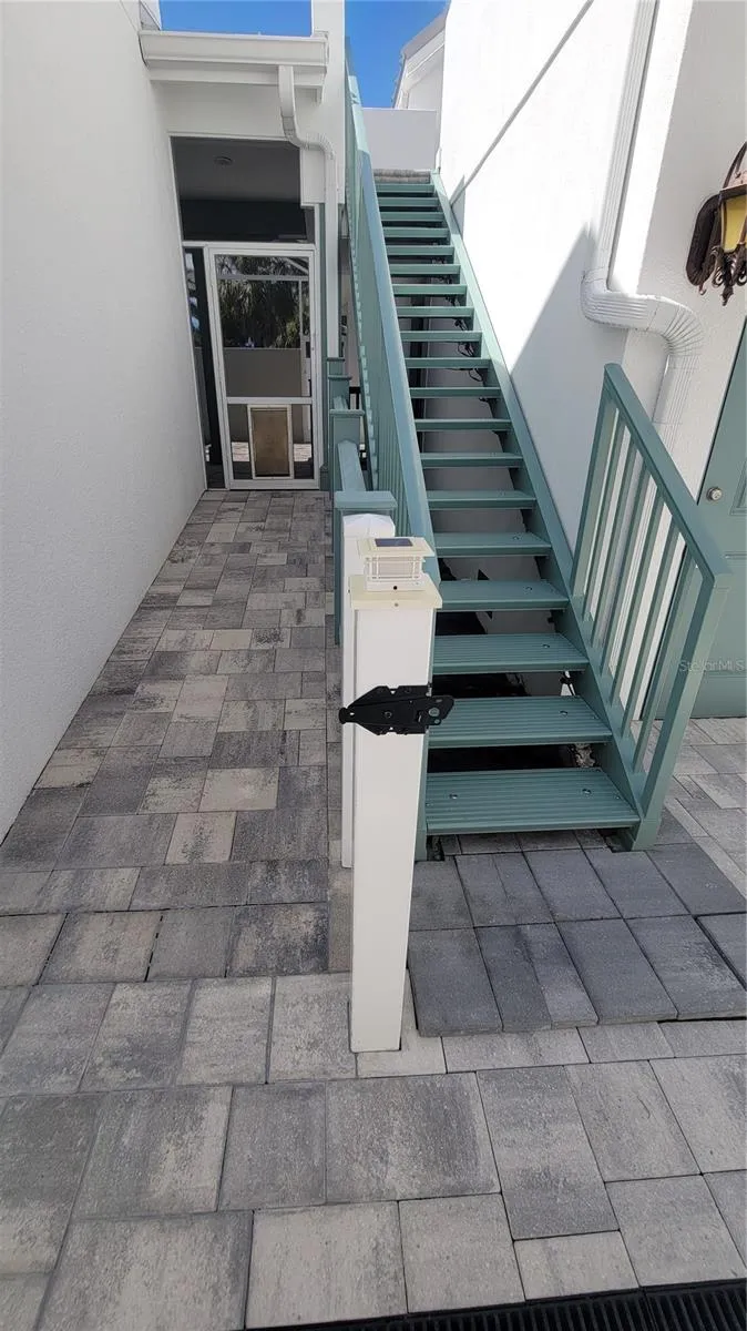 Staircase to in-law suite and door to pool
