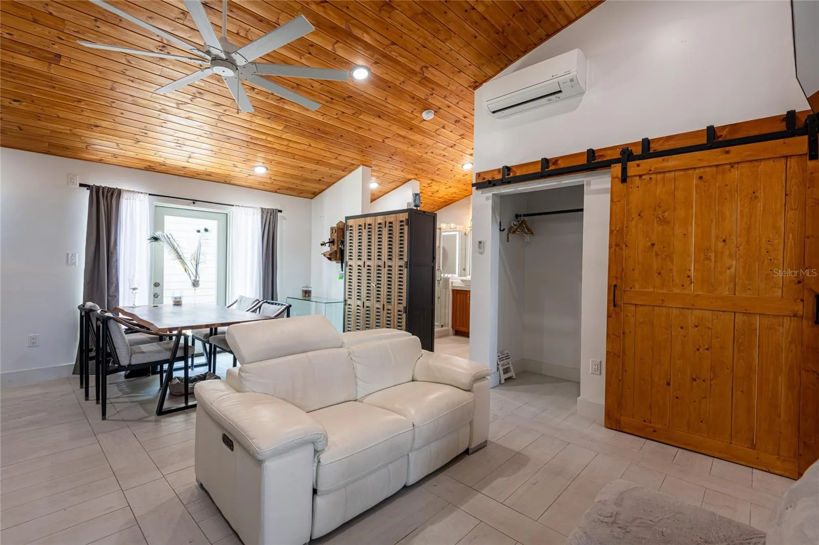 Picture showing the barn doors closed concealing the washer and dryer and opening a storage and/or closet.