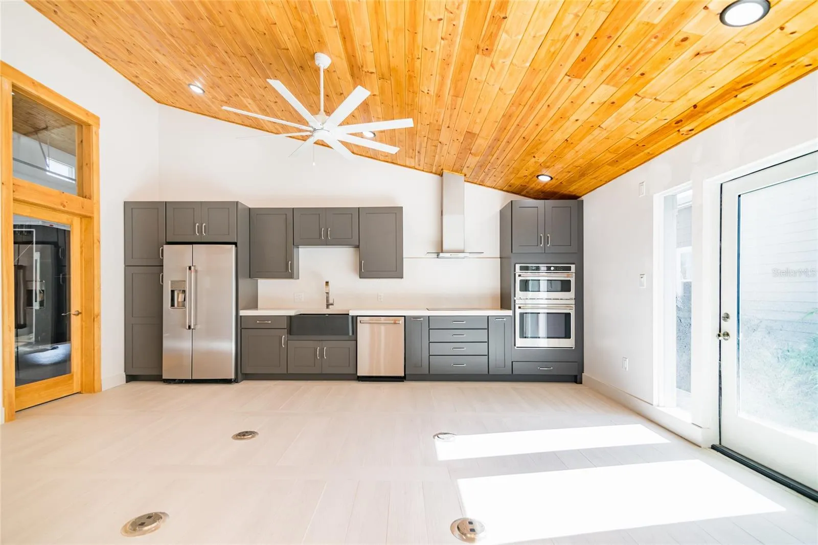 Kitchen and open space - showing without the existing furnishings.  Door on right leads to the hot tub.