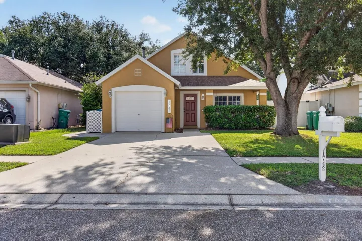 Beautifully maintained front exterior with fresh landscaping, shaded driveway, and welcoming entry. Located in a quiet, well-kept neighborhood.