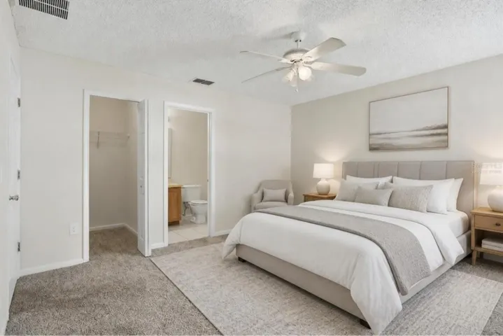 Virtually staged - primary bedroom with walk-in closet and bath