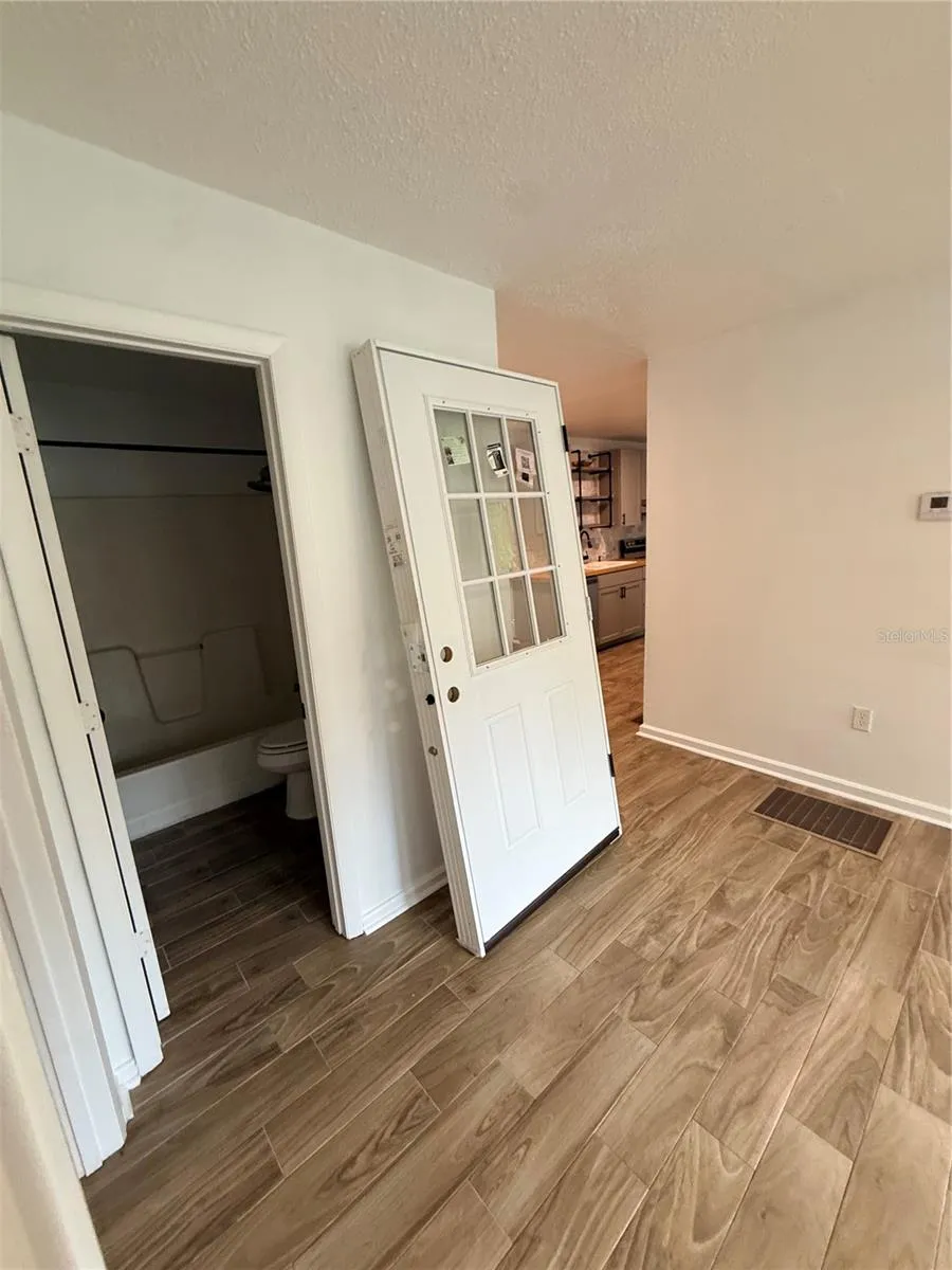 Living room with view of full bathroom (Door to be removed)