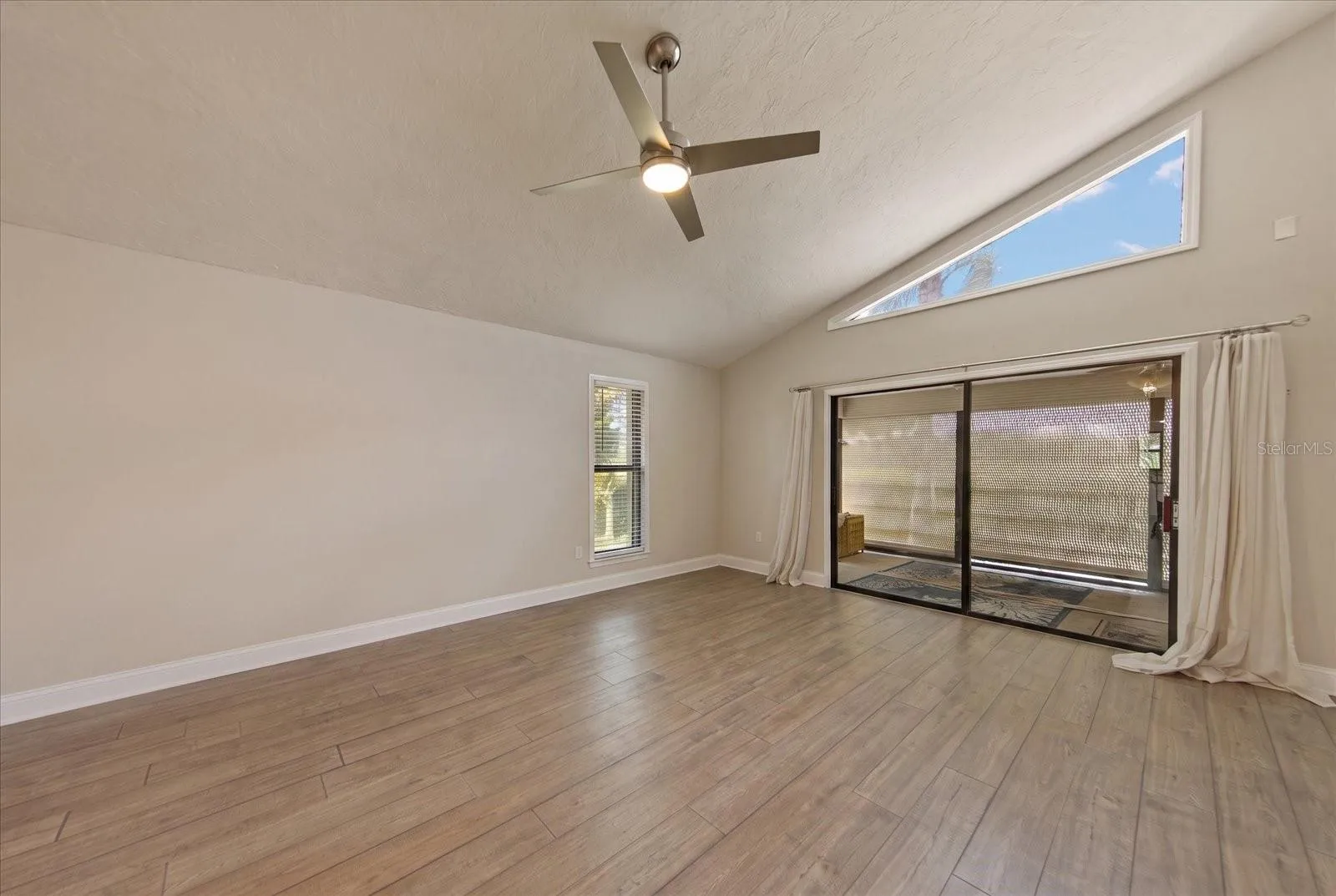 LIVING ROOM WITH VIEW OF SCREENED PATIO
