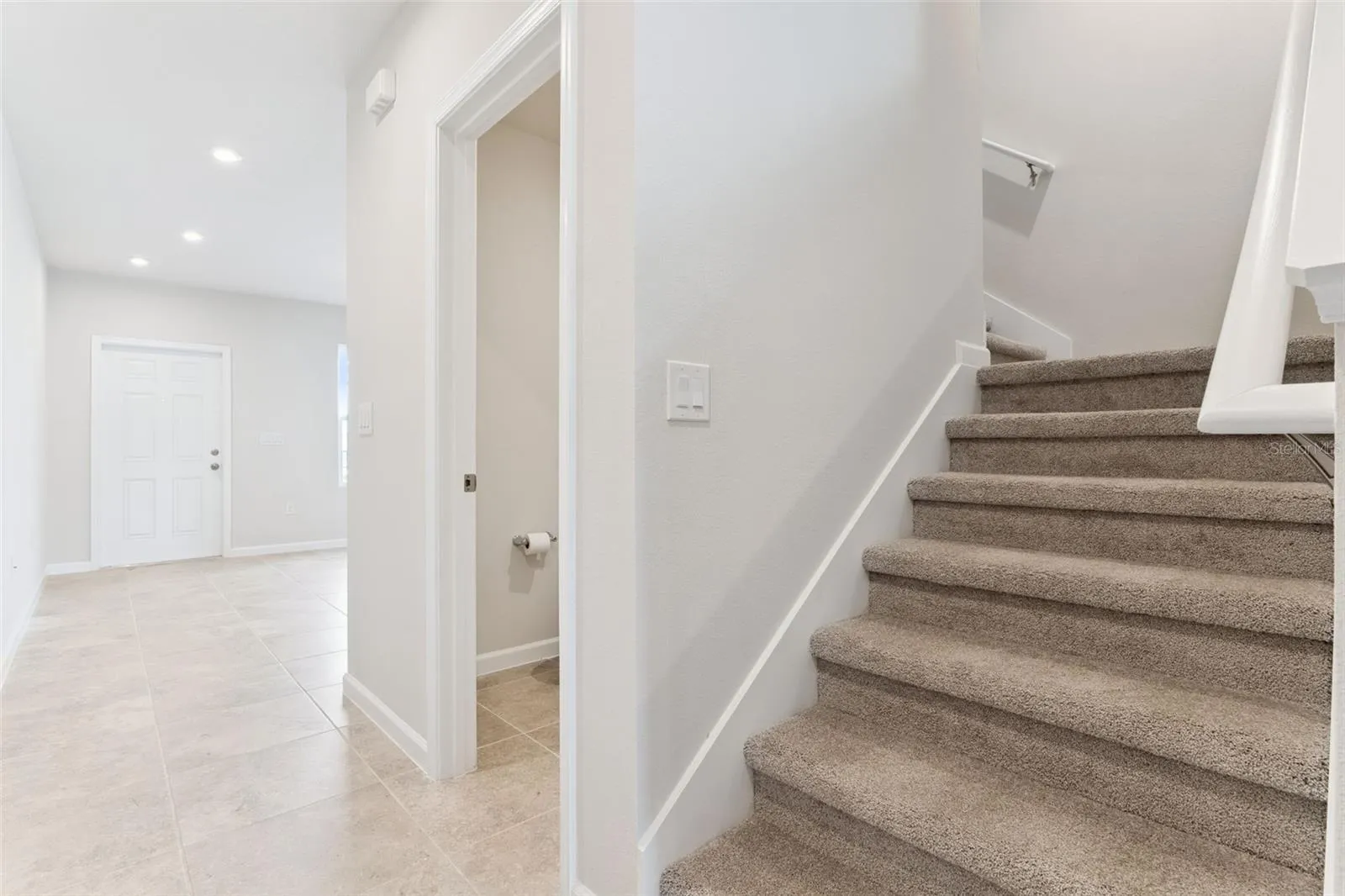 Stairs lead to 2 bedrooms and one full bath
