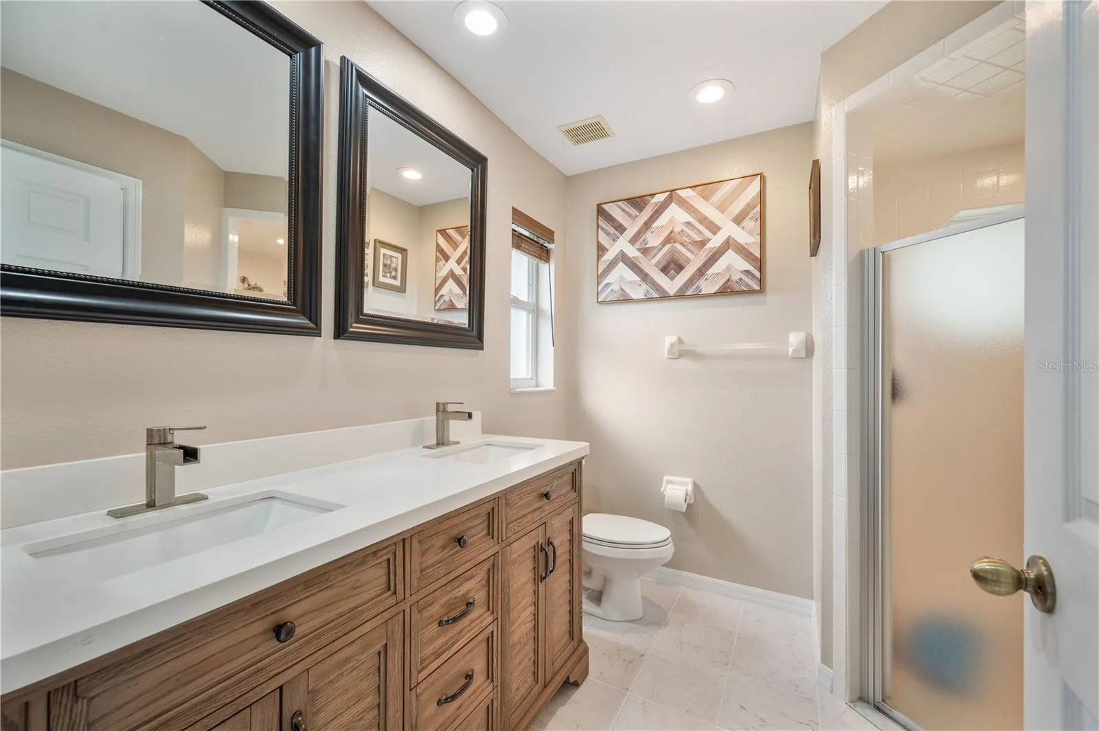 Primary bedroom ensuite with walk in shower and dual vanities!
