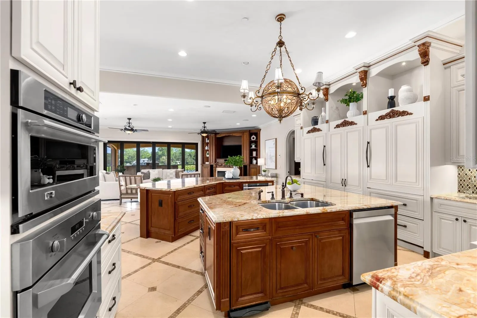 The chef's kitchen also features GE Monogram ovens, an integrated warming drawer and a hidden walk-in pantry with extensive custom shelving.
