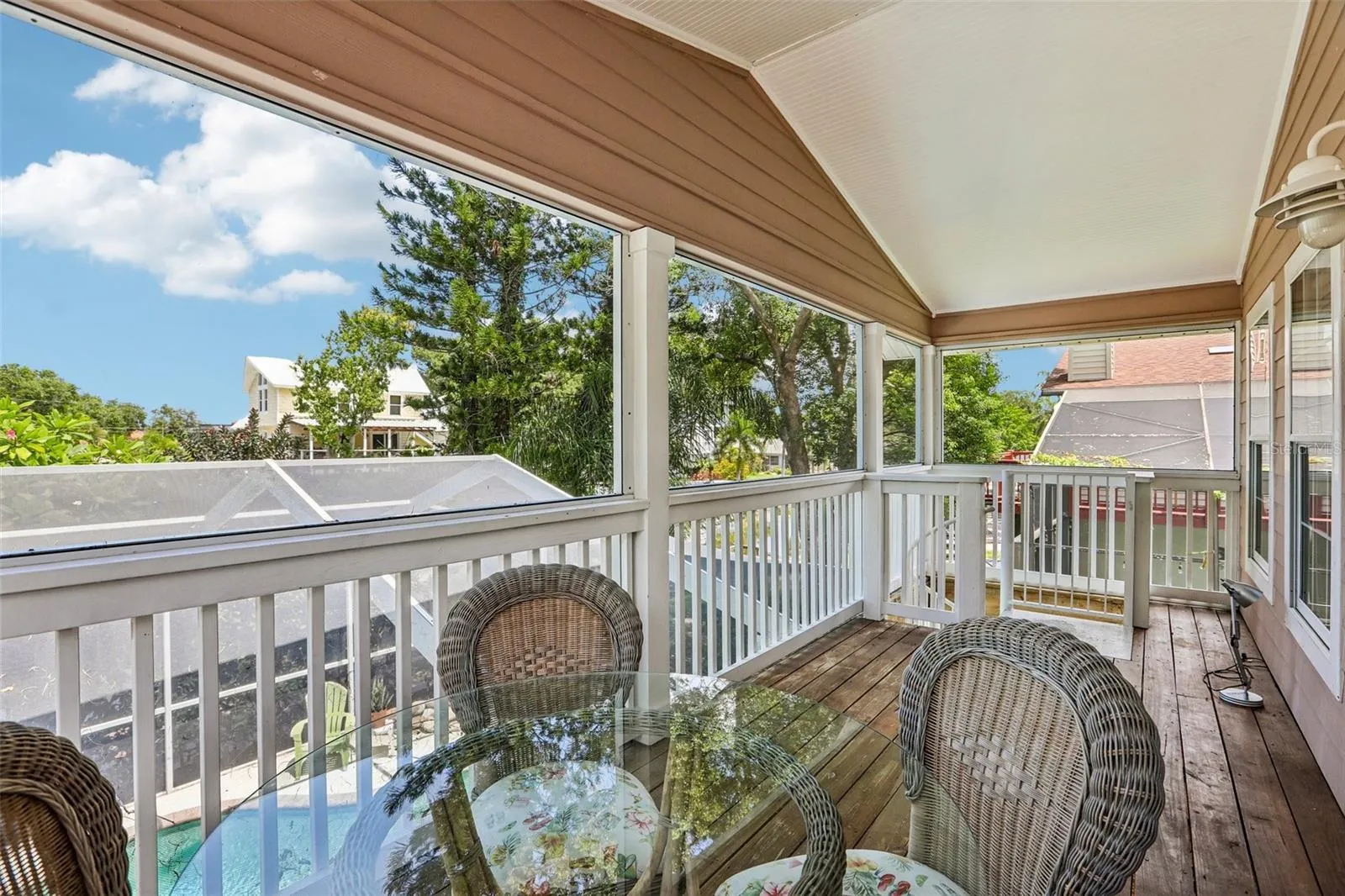 Second floor screened patio and stairs to the pool area