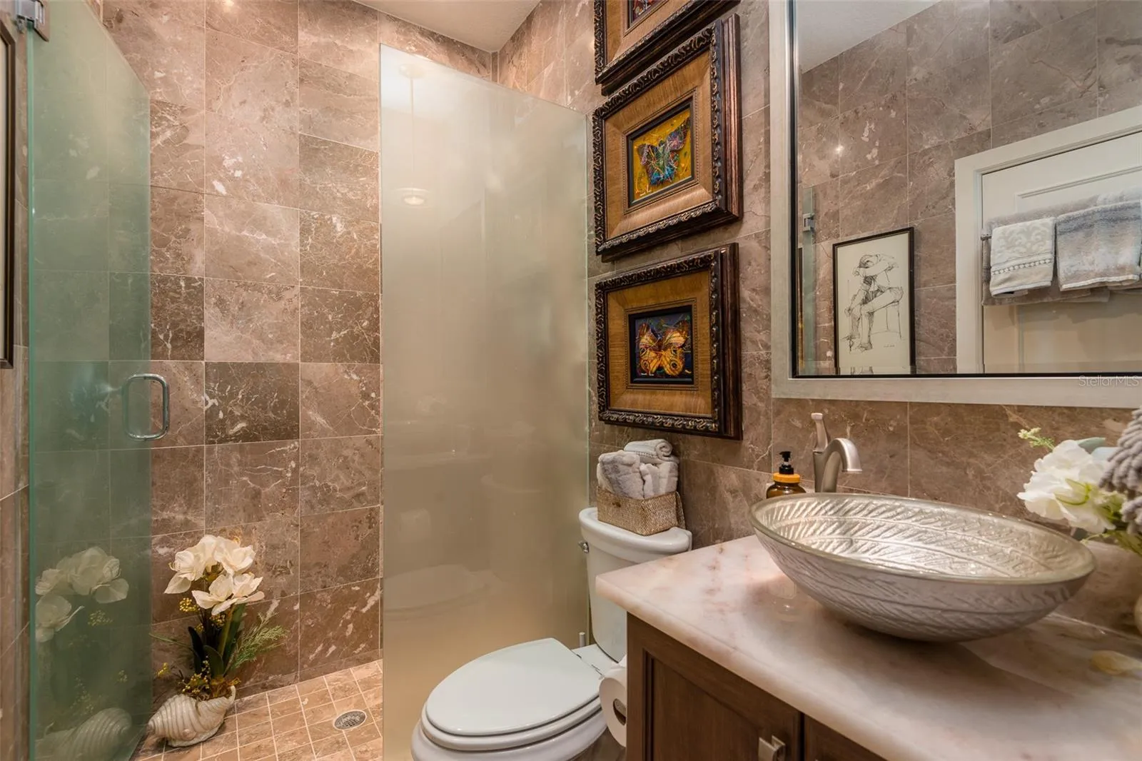 First floor full bath highlighting tile and quartz vanity top with bowl sink