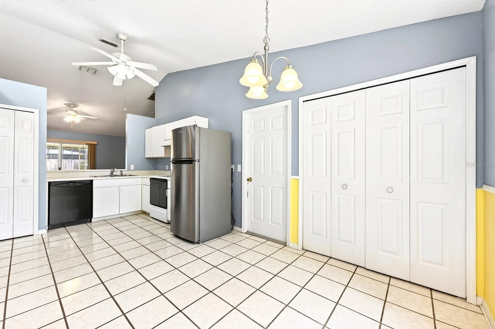 The Kitchen offers crisp WHITE CABINETRY, a closet pantry and a SPACIOUS DINING AREA filled with natural light.