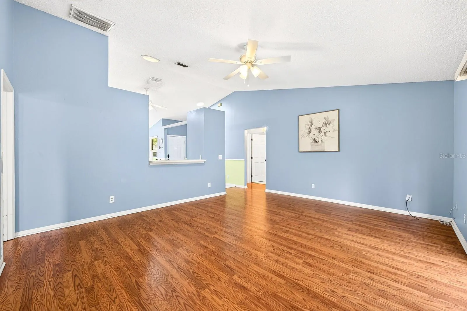 Beautiful LAMINATE FLOORING flows through the Living Room.