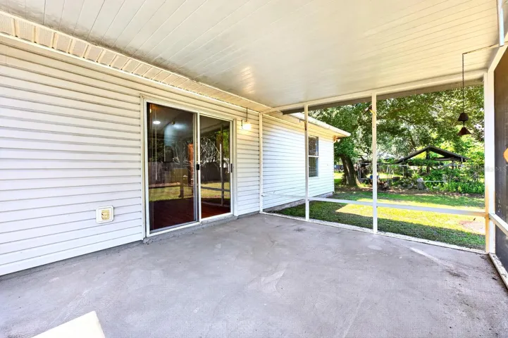 Outside, the covered and screened porch provides a comfortable spot to enjoy the GENEROUS BACKYARD.
