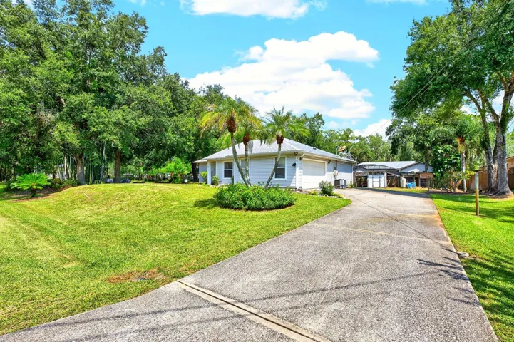 The home also offers a 2-CAR SIDE-ENTRY GARAGE and several important updates including a NEW ROOF (2018), NEW A/C (2019) and NEW WATER HEATER (2023).