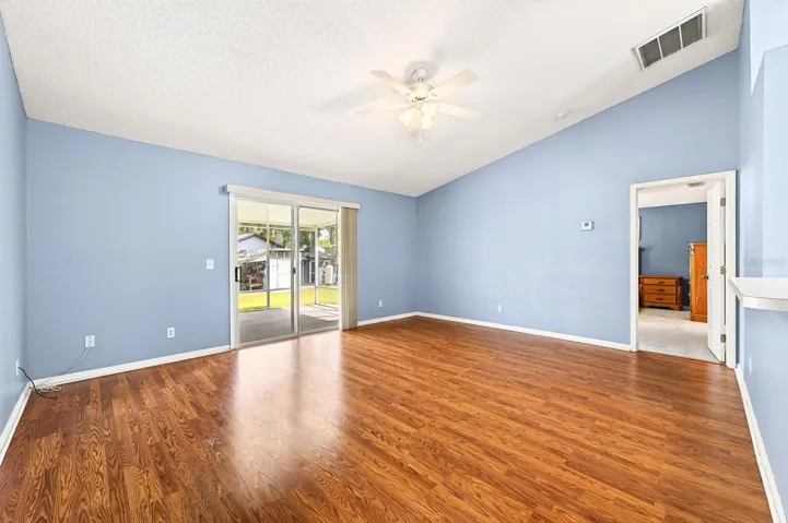 Sliding glass doors in the Living Room lead to the COVERED &amp; SCREENED PORCH.