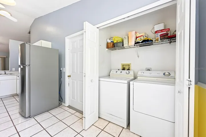 A convenient LAUNDRY CLOSET is tucked into the Kitchen and includes the WASHER &amp; DRYER and shelving for storing supplies.