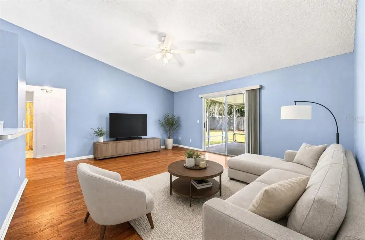 Sliding glass doors in the Living Room lead to the COVERED &amp; SCREENED PORCH. Virtually Staged