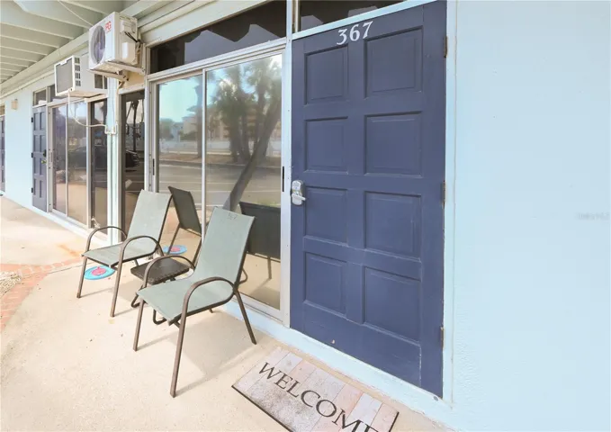 Front door, parking spaces close by out front.