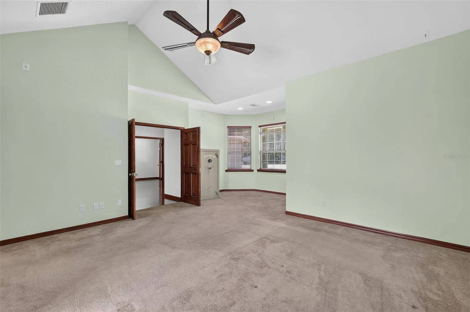 Spacious enough for any furniture arrangement, the primary bedroom offers a cozy window nook perfect for a reading chair or vanity.