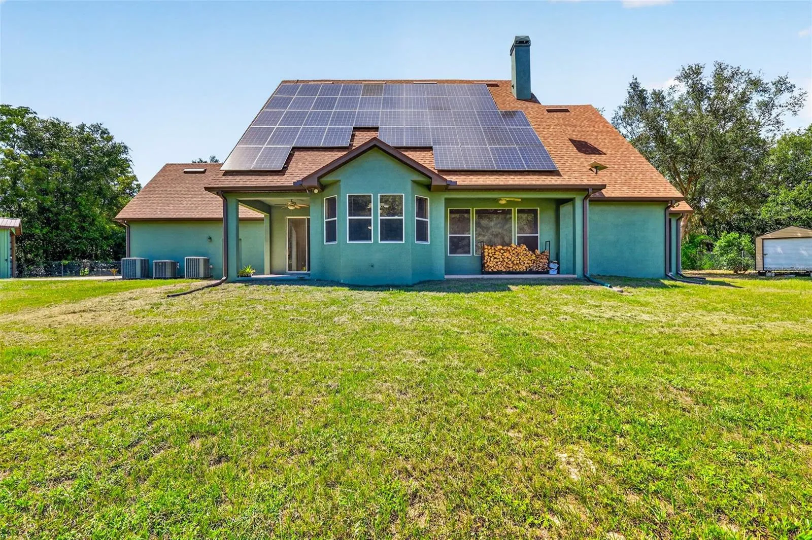Multiple outdoor living zones and a generous flat yard provide endless potential for a pool, garden, or outdoor kitchen.