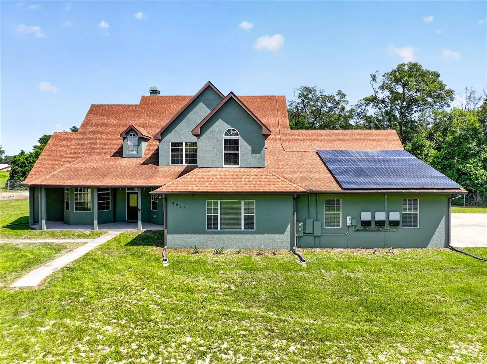 Classic architectural details meet modern energy efficiency with an owned solar panel system.