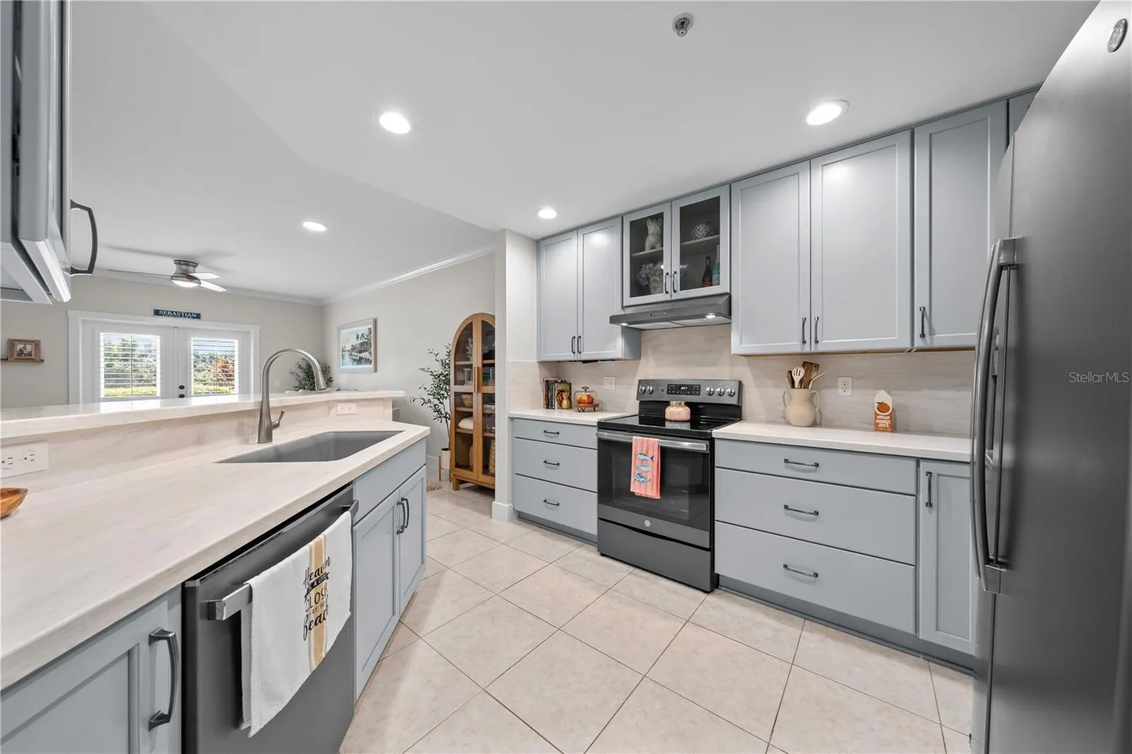 Kitchen features showcase cabinets, quartz countertops and stainless appliances.