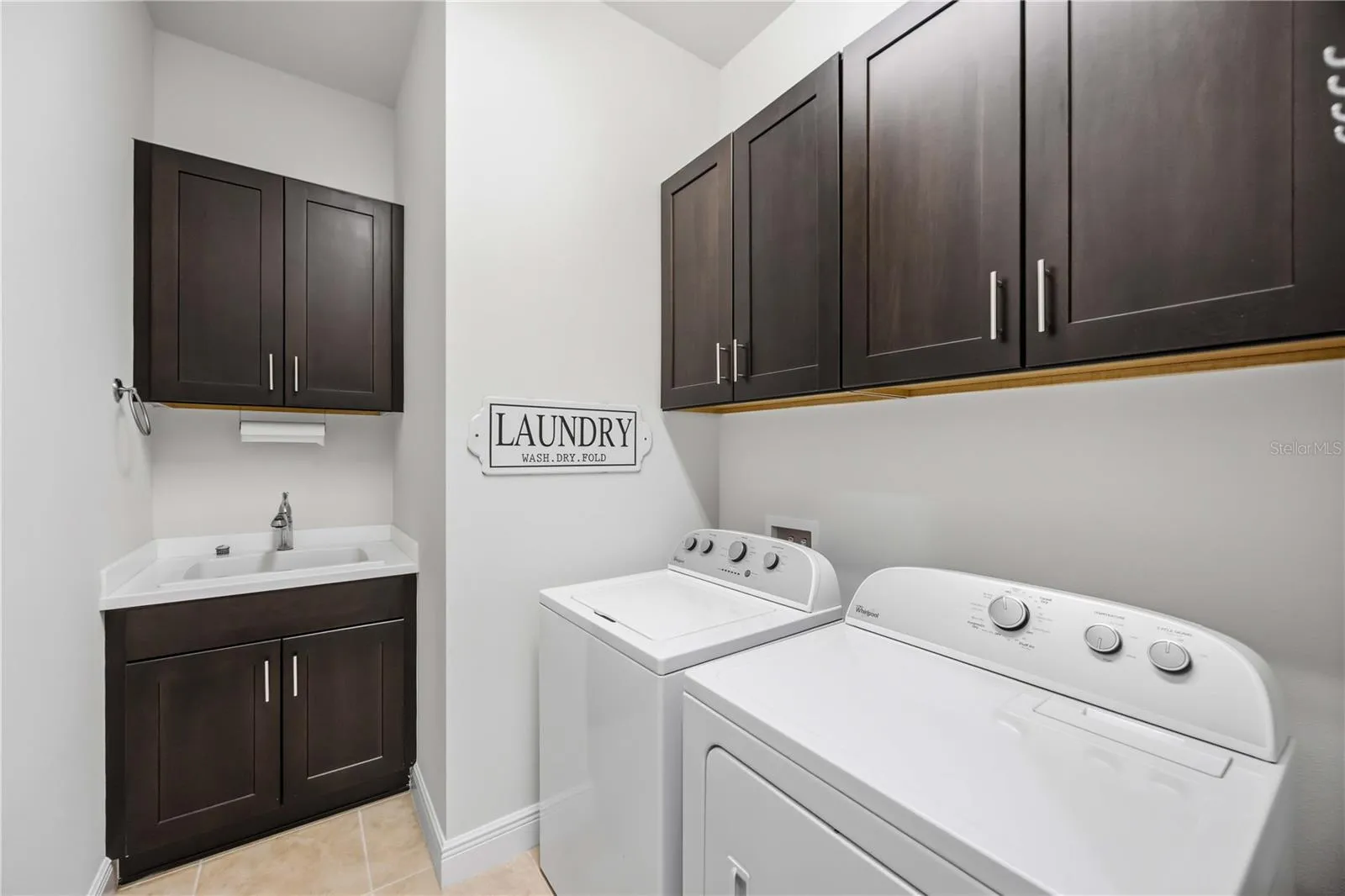 The laundry area has a utility sink and washer /dryer.