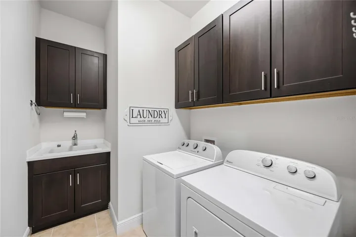 The laundry area has a utility sink and washer /dryer.