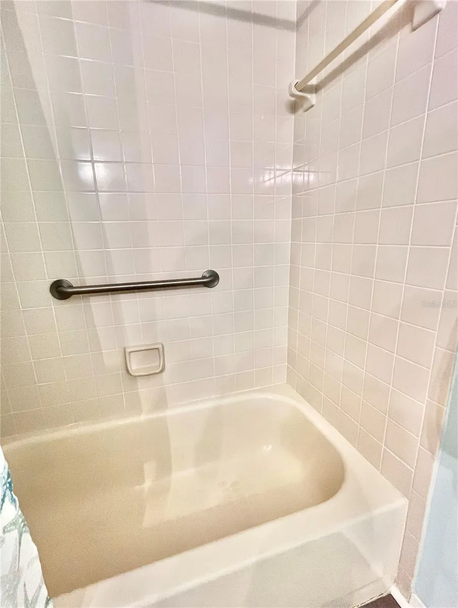 2nd bath has a tub with curtain for shower