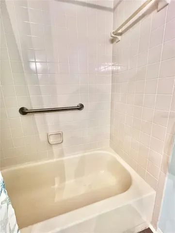 2nd bath has a tub with curtain for shower
