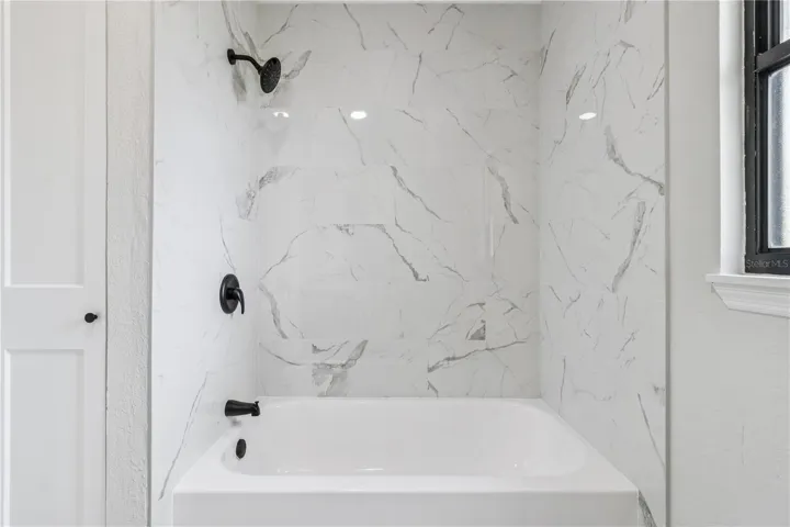 Main bathroom with tub and shower