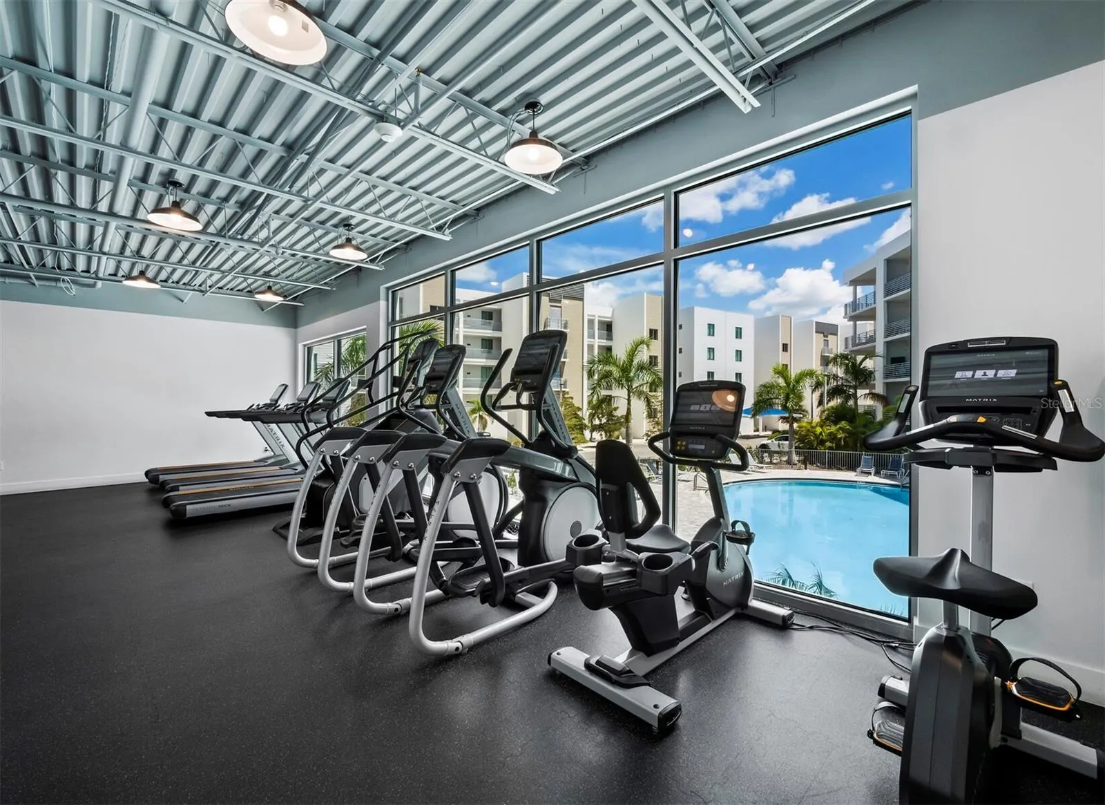 Well equipped fitness center overlooking pool