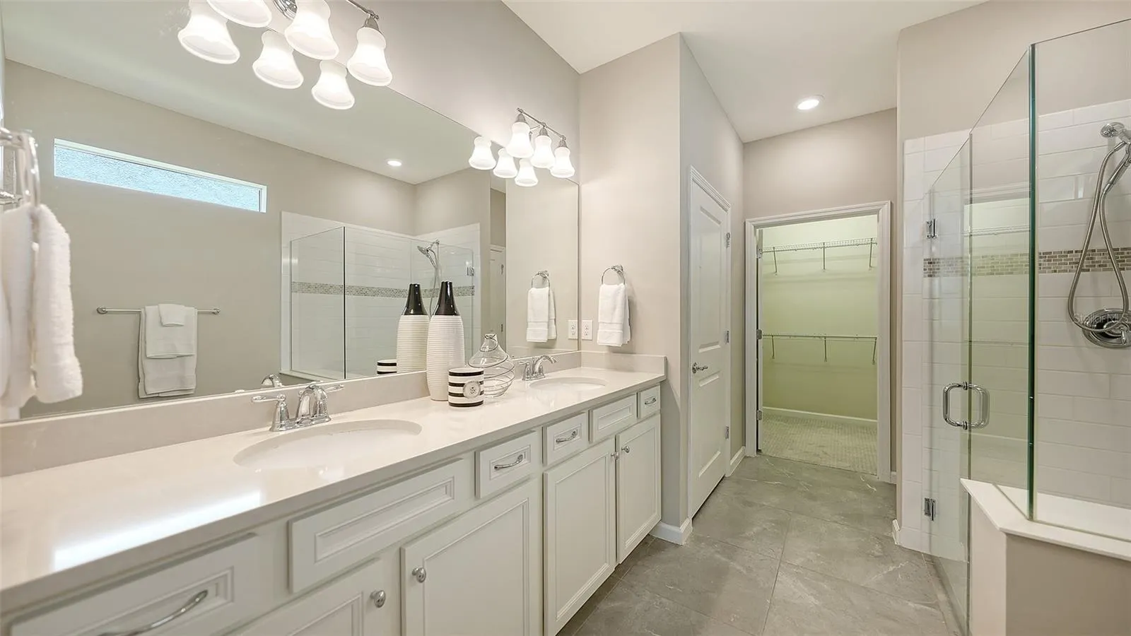 Primary Bath w/Dual Sinks, Step-In Shower, Frameless glass, and Listello Accent Tile