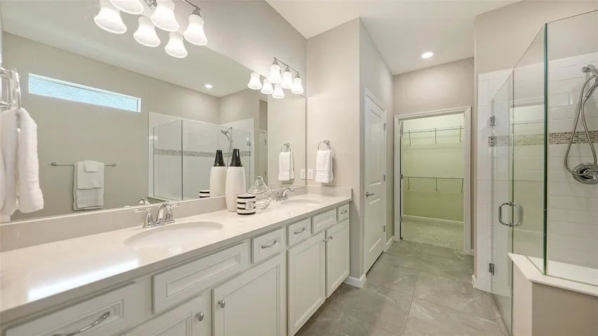 Primary Bath w/Dual Sinks, Step-In Shower, Frameless glass, and Listello Accent Tile