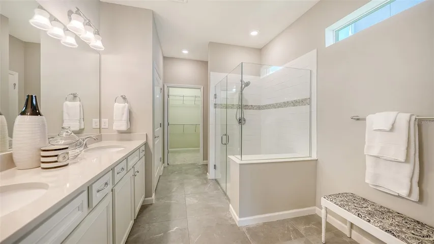 Primary Bath w/Dual Sinks, Step-In Shower, Frameless glass, and Listello Accent Tile