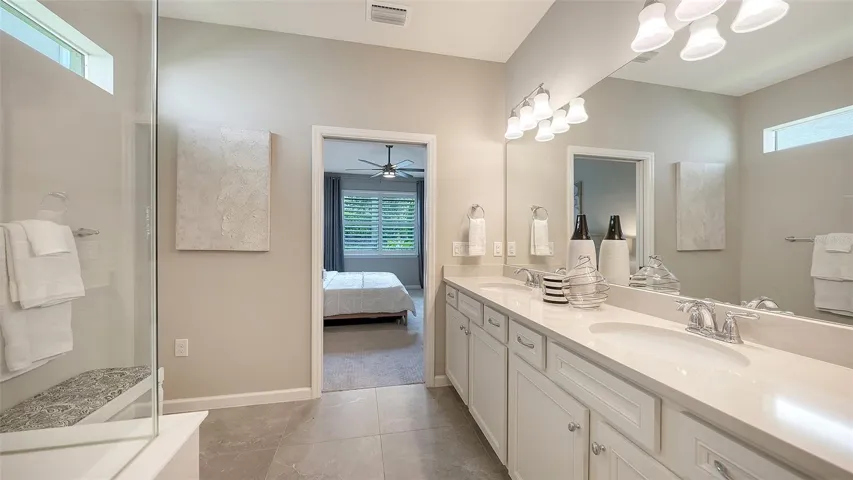 Primary Bath w/Dual Sinks, Step-In Shower, Frameless glass, and Listello Accent Tile